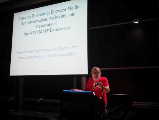 A photograph of Howard Besser giving a slide-show presentation