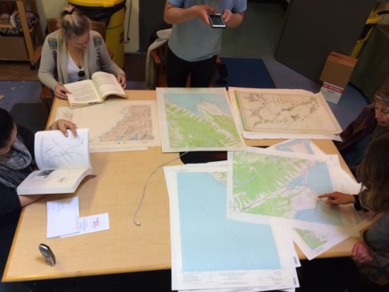 Melinda Stone examines the Prelinger Library's map collection with her University of San Francisco students