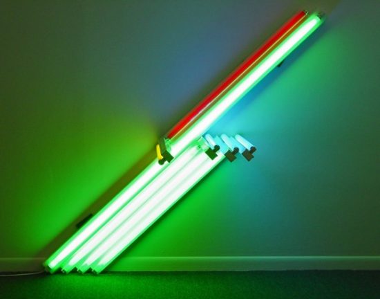 A photograph of a fluorescent light tube sculpture in green, blue, yellow, and red