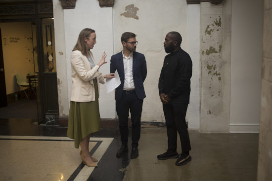 Lauren Shadford, Chad Alligood, and artist Derrick Adams speak to one another in the Stony Island Arts Bank in Chicago