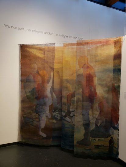 A photograph of a hanging fabric artwork