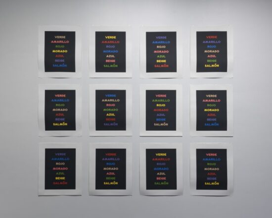 A photo of a grid of 12 posters that comprise the artwork Prueba de colores y palabras by Kerry Tribe