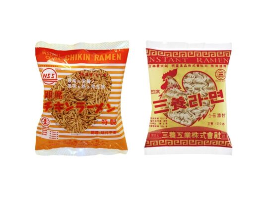 Two packets of ramen noodles, left one in orange and white striped packaging and the right in yellow and red with a chicken on the front.