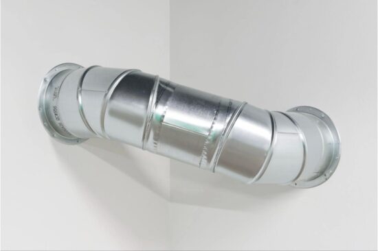 A silver aluminum pipe, 12 inches in diameter and 40 inches long, fixed at each end to corner walls of the gallery.