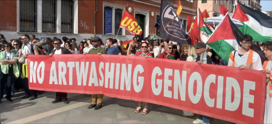 People gathered and holding a large sign